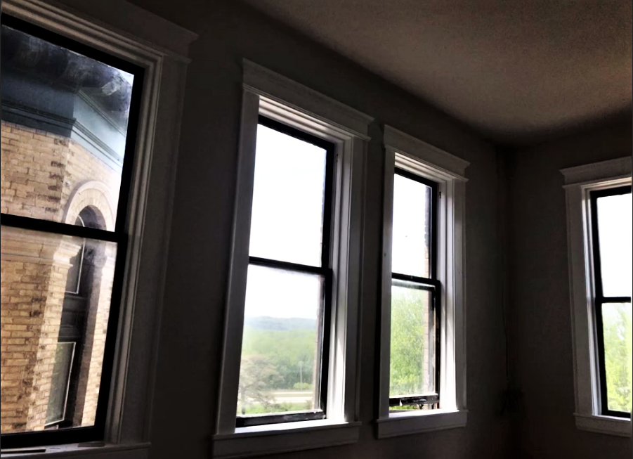 a row of windows with a view of a brick building