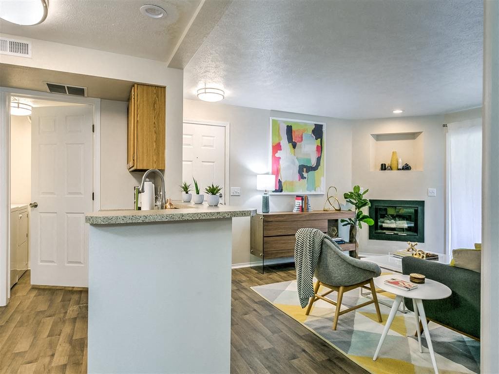 A modern kitchen with a white island and a chair in front of it.