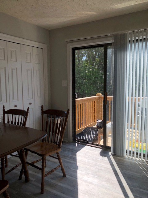 a dining room with a sliding glass door to a balcony
