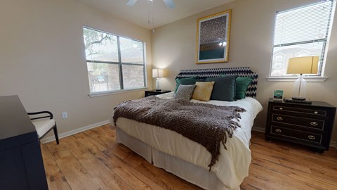 a bedroom with hardwood floors and grey walls