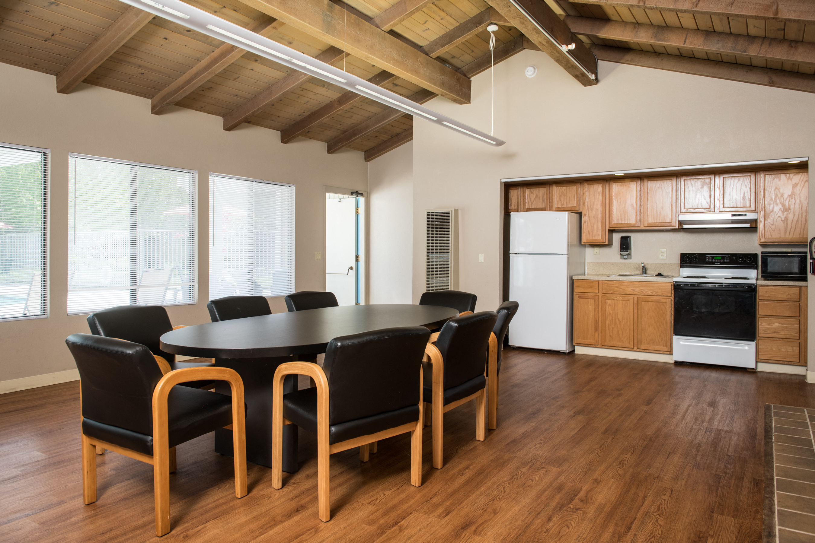 a dining room with a table and chairs and a kitchen