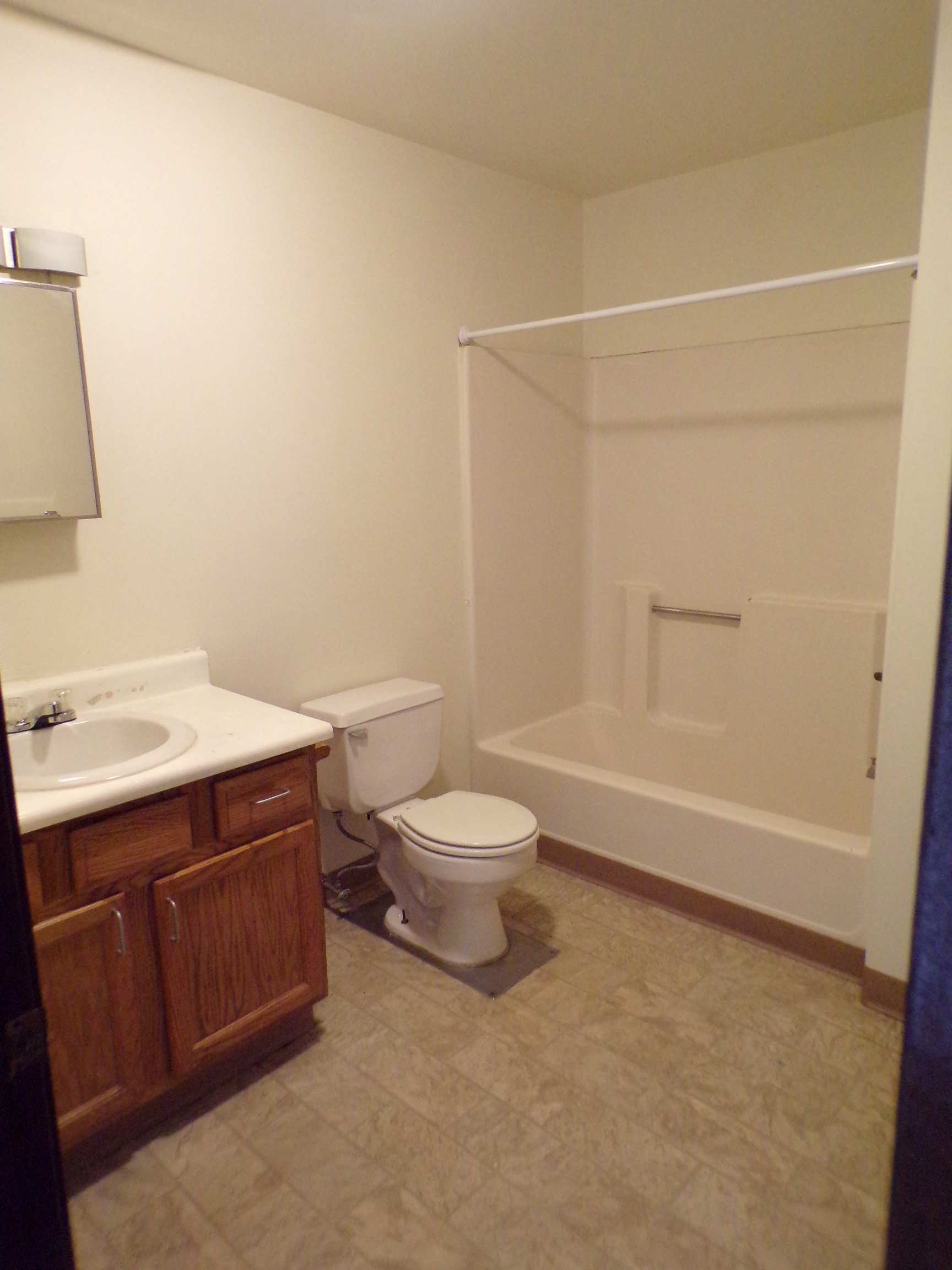 a bathroom with a toilet and a sink and a shower