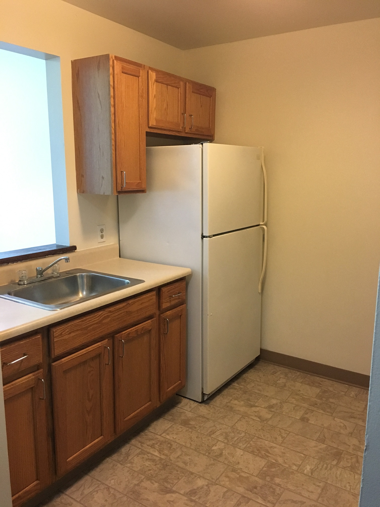 a kitchen with a sink and a refrigerator