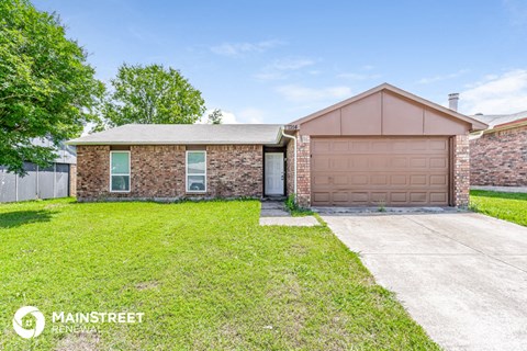 a brick house with a driveway and a garage door
