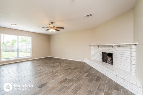 the living room has a fireplace and a large window
