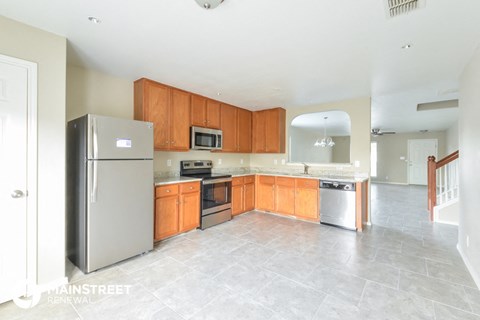 a large kitchen with wooden cabinets and stainless steel appliances