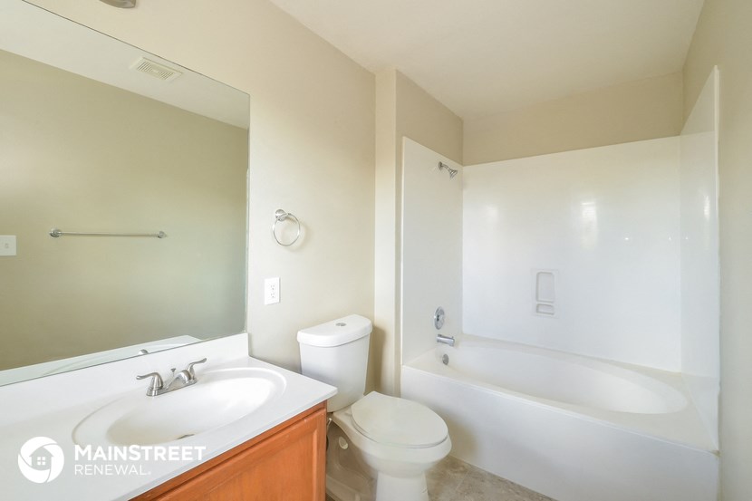 a bathroom with a sink and a toilet and a bath tub