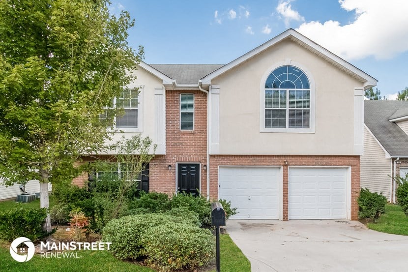 a house with two garage doors and a driveway