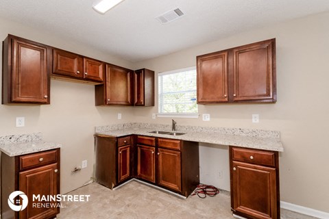 a kitchen with wooden cabinets and granite counter tops