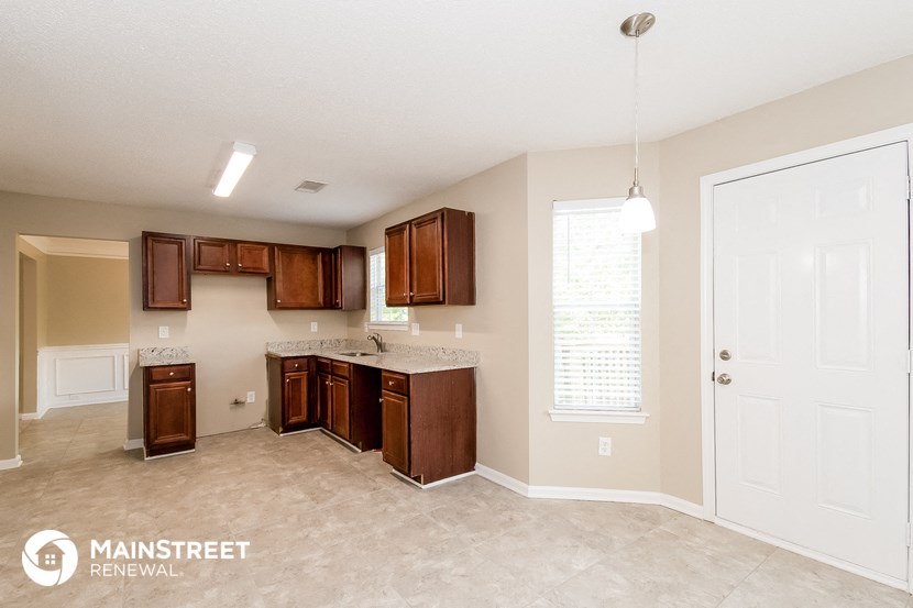 a kitchen with wooden cabinets and a counter top and a sink
