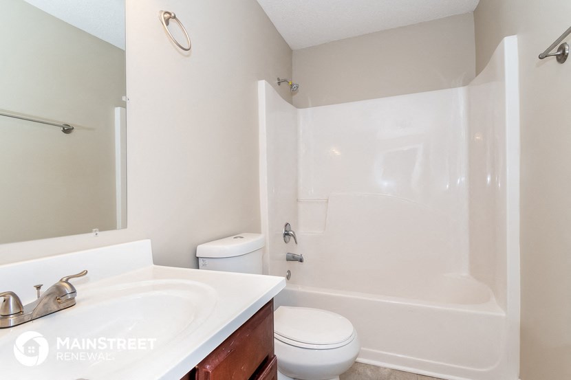 a bathroom with a sink toilet and a shower