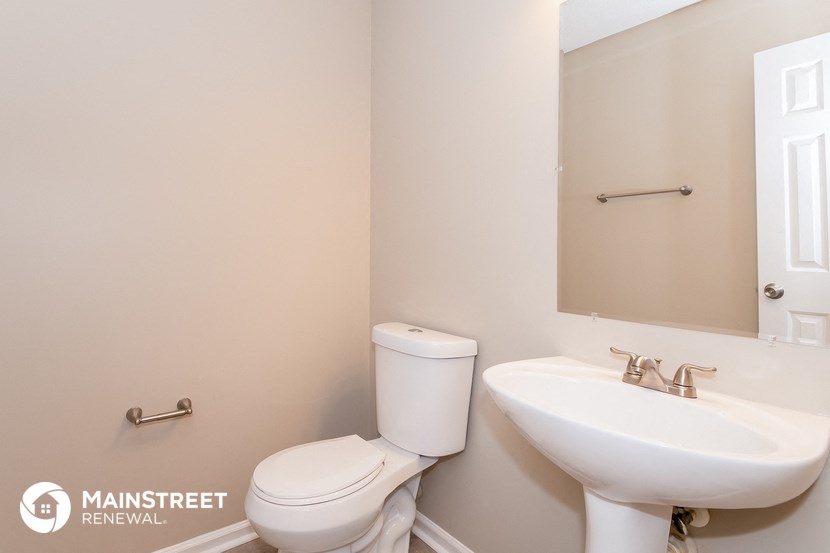 a bathroom with a sink and a toilet and a mirror