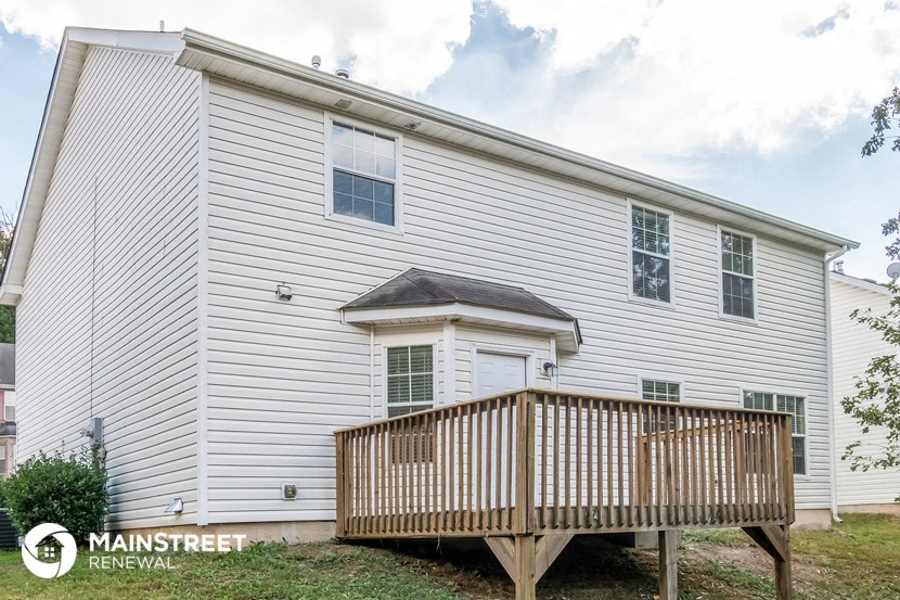a white house with a porch and a deck