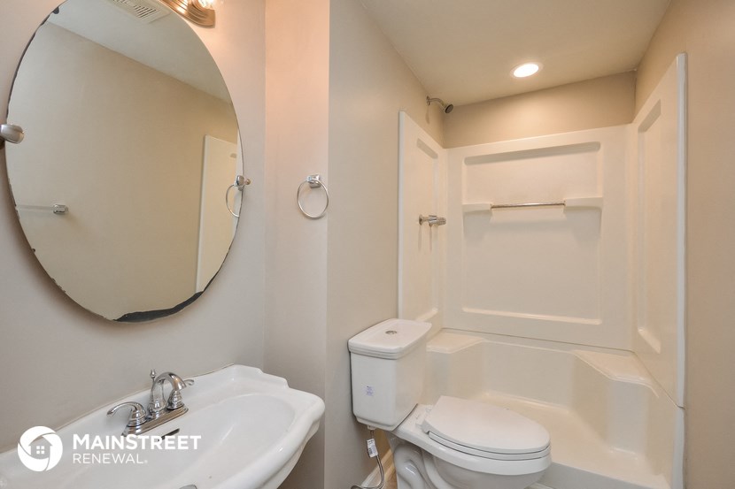 a small bathroom with a sink toilet and a bath tub