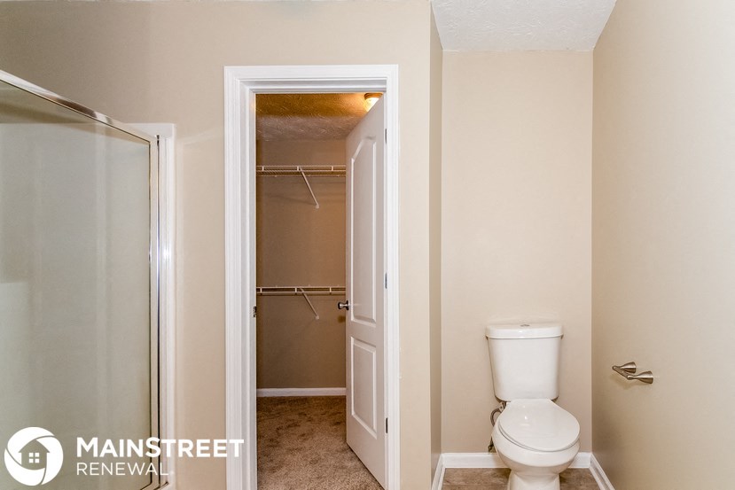 a small bathroom with a toilet and a shower