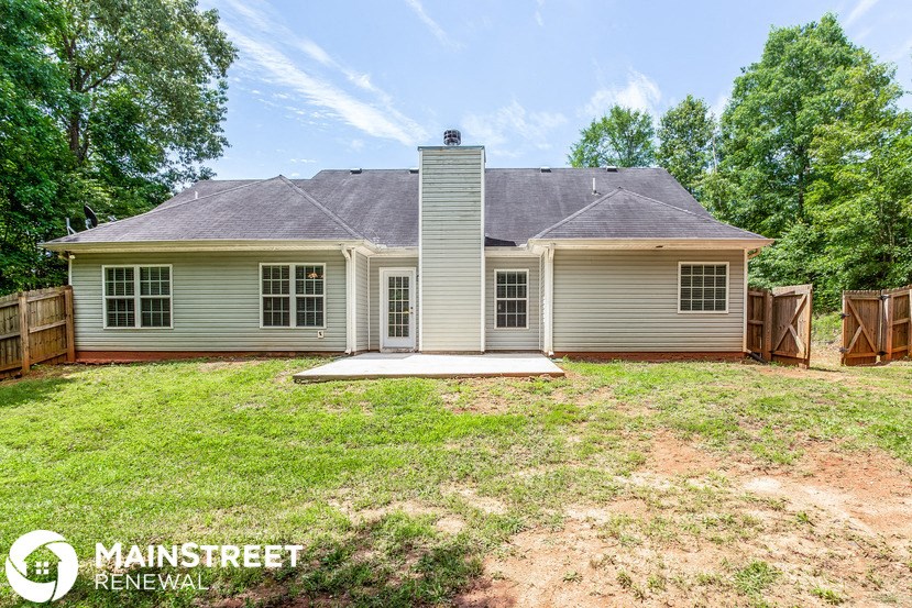 a white house with a yard and a fence
