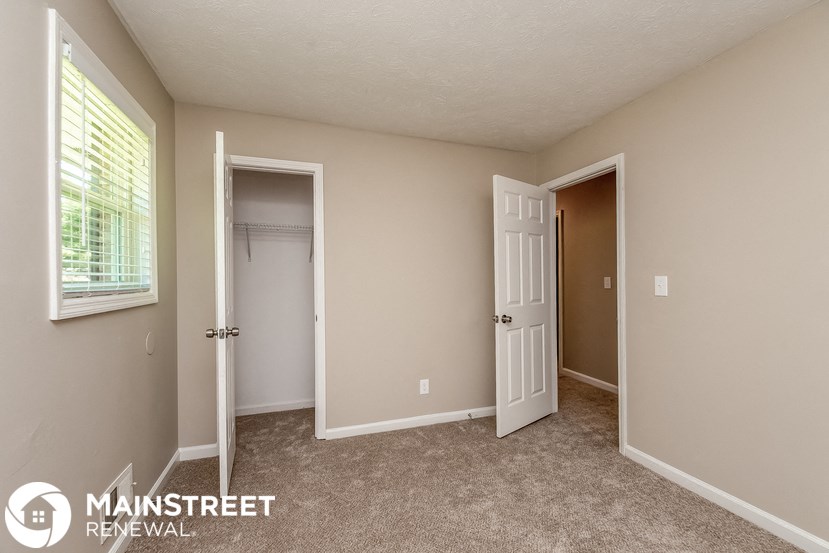 a bedroom with a closet and an open door