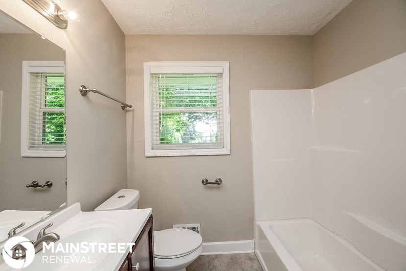 a bathroom with a shower toilet and sink and a bath tub