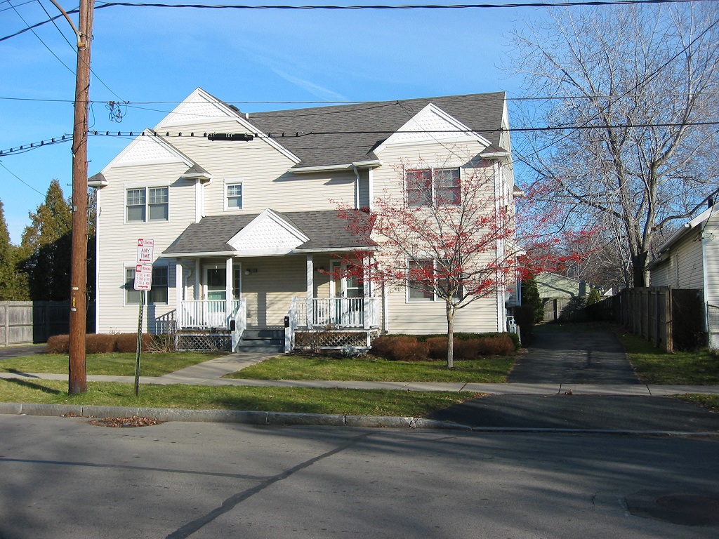 a white house on the corner of a street