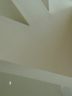a view of a kitchen from the bottom of the stairs