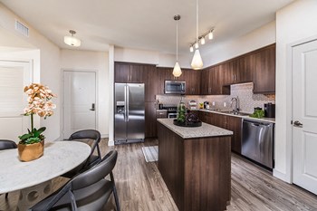 kitchen island with wood look flooring at Rize Irvine Apartments in Irvine, CA - Photo Gallery 3
