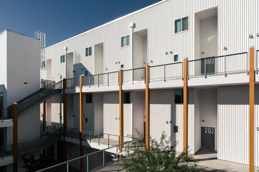 the exterior of a building with stairs and a balcony
