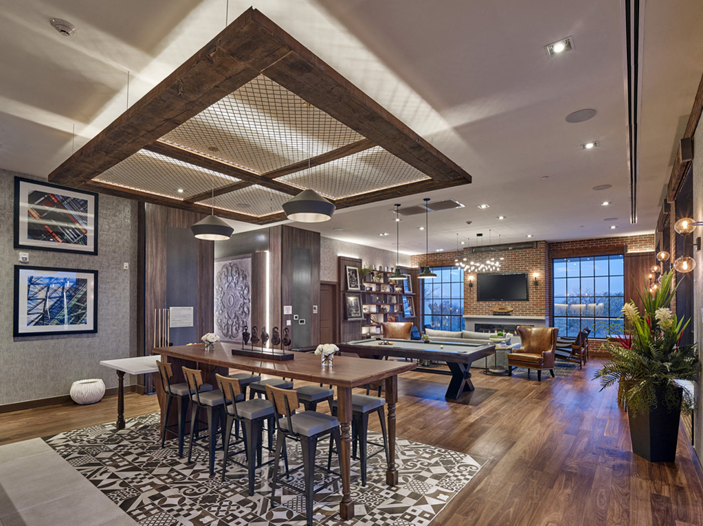 a living room with a table and a billiards table