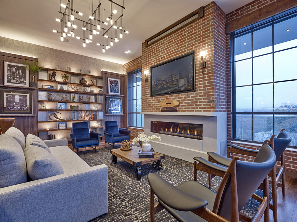 a living room with a couch and chairs and a fireplace