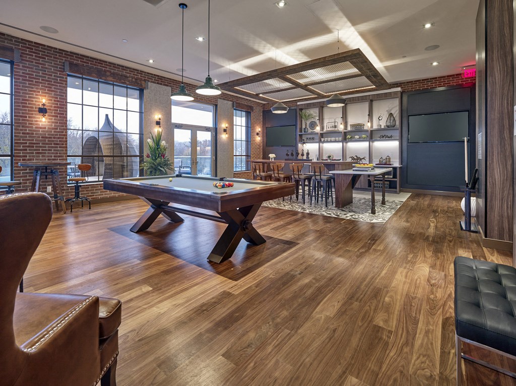 a game room with a pool table and a bar