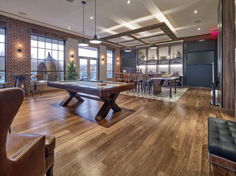 a game room with a pool table and a bar