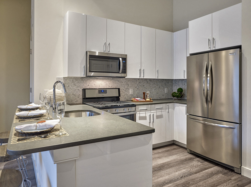 a kitchen with stainless steel appliances and white cabinets