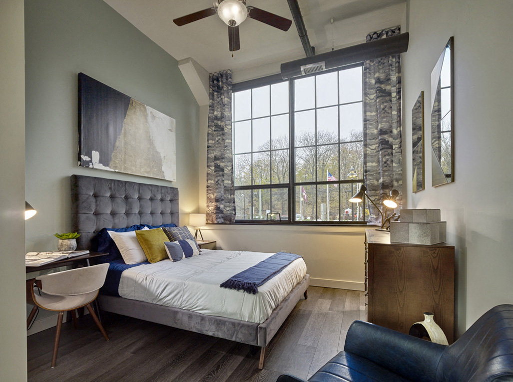 a bedroom with a bed and a ceiling fan