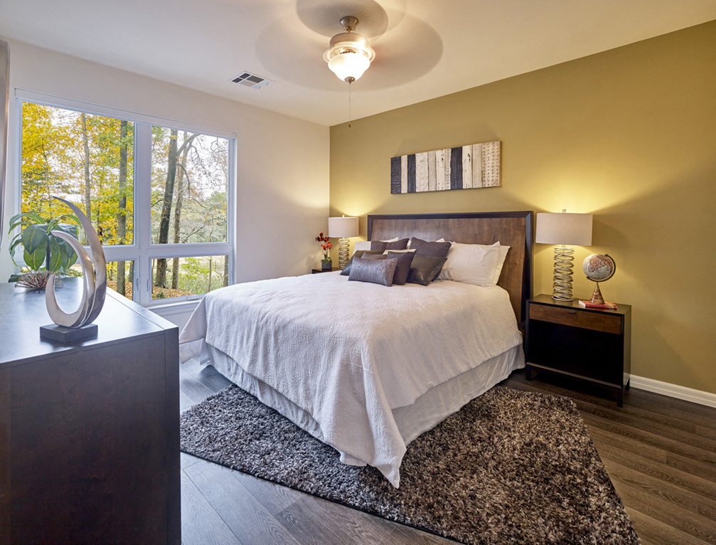 a bedroom with a large bed and a window