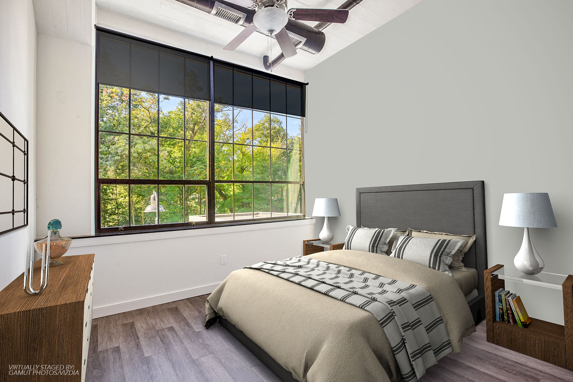 a bedroom with a bed and a large window