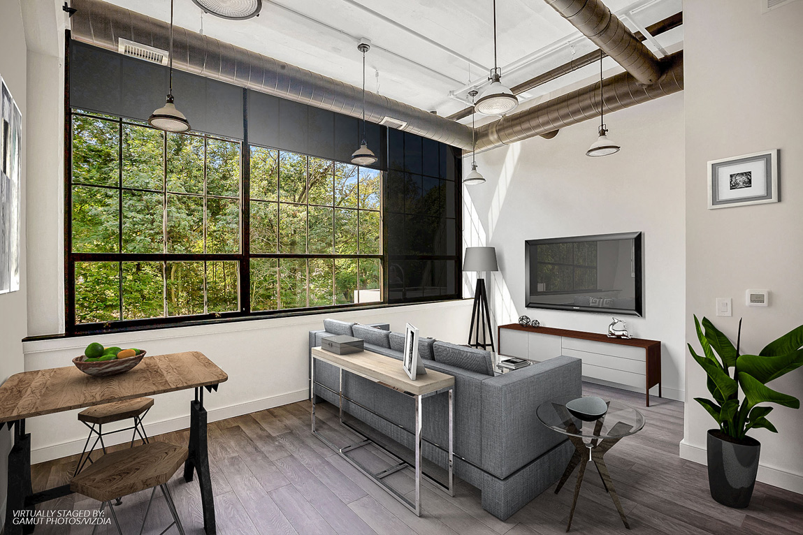 a living room with a gray couch and a tv