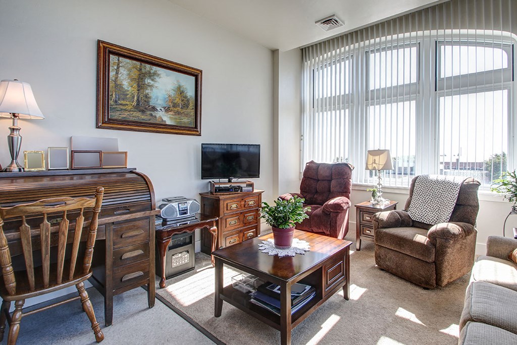 a living room with furniture and a large window