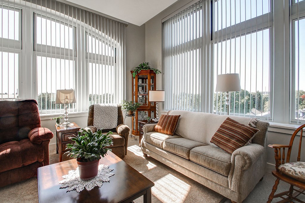a living room with large windows and a couch