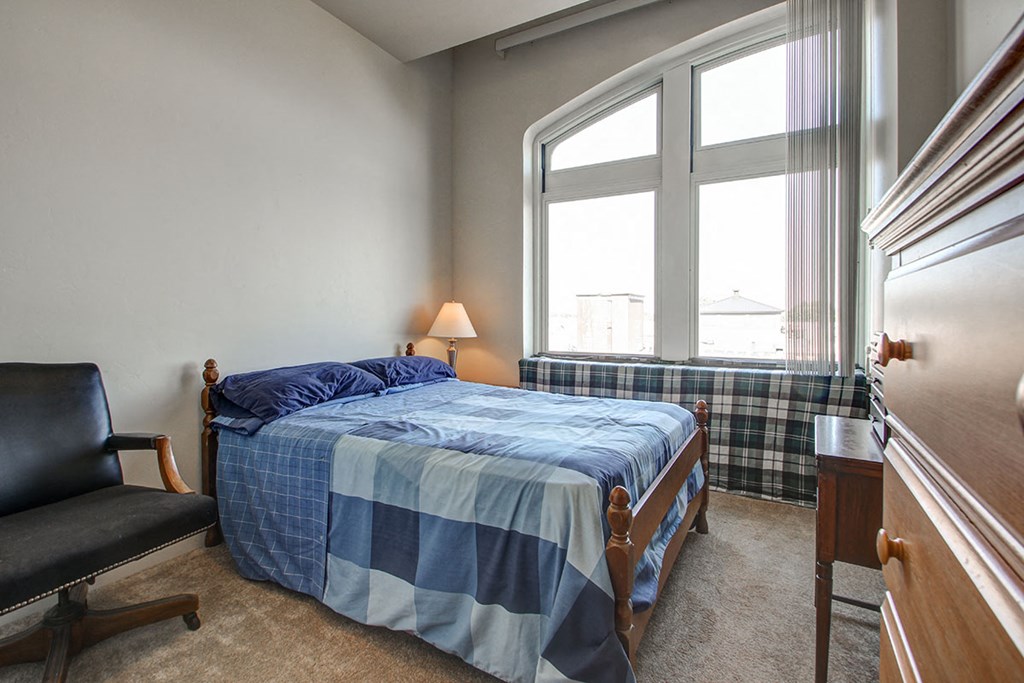 a bedroom with a bed and a window