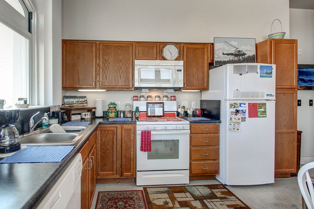 a kitchen with a stove microwave and refrigerator