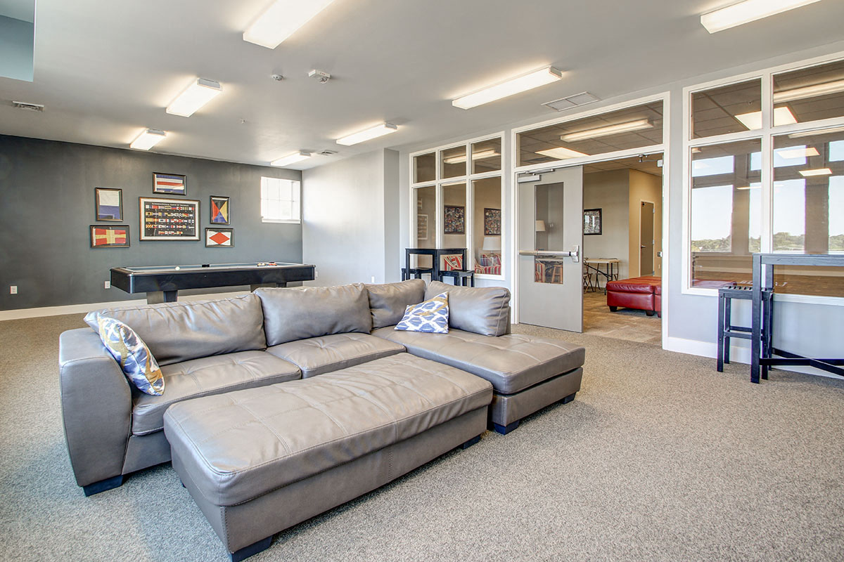 a living room with a couch and a pool table