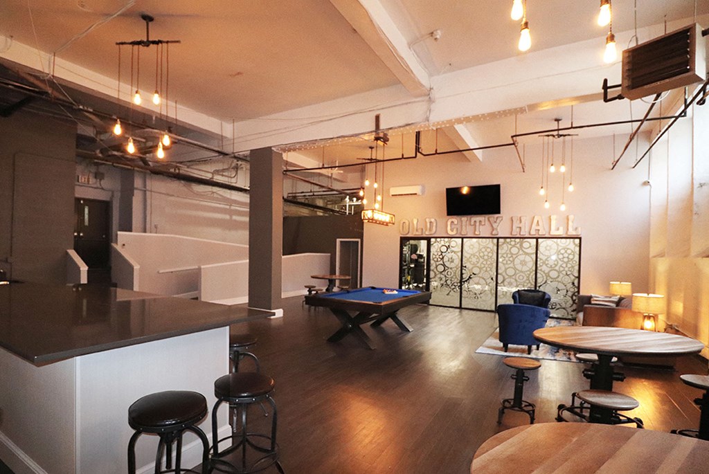 a game room with a pool table and a bar