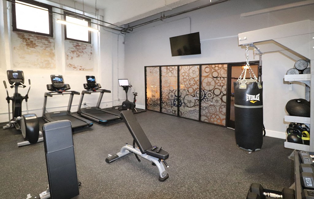 a gym with weights and a punching bag