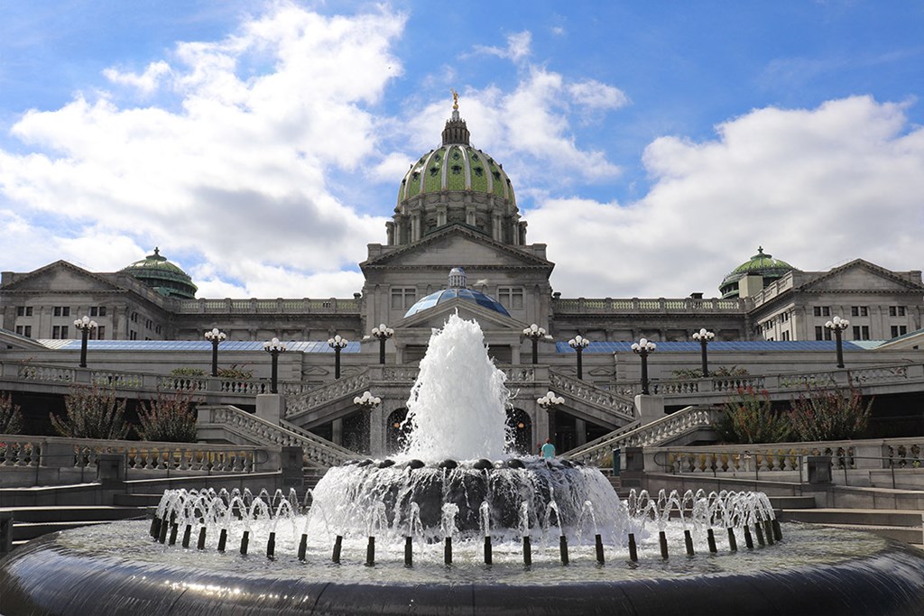 a fountain in front of a large building