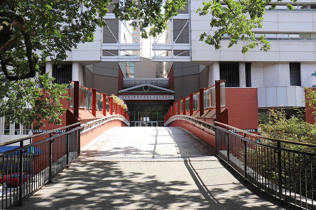 a bridge leading to an office building with a driveway