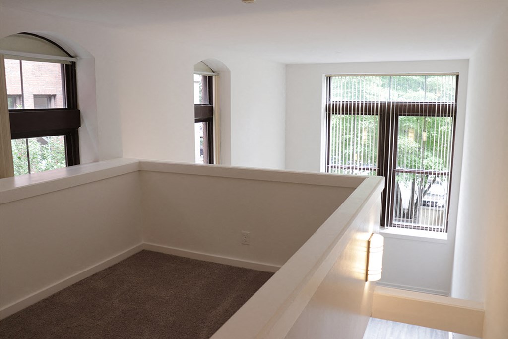 a empty room with a balcony and a window