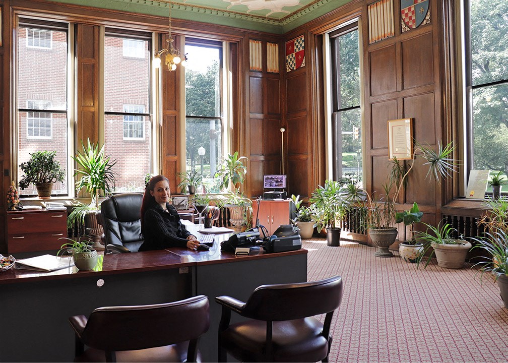 a woman sitting at a desk in an office