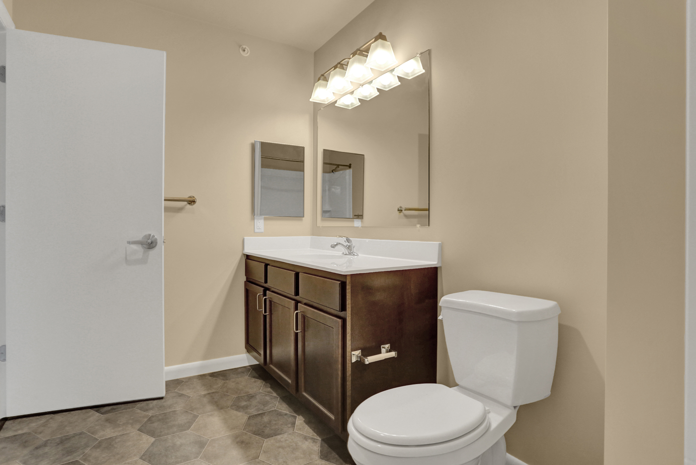 an empty bathroom with a toilet sink and mirror