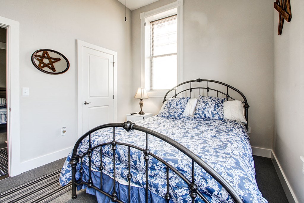 a small bedroom with a bed and a window