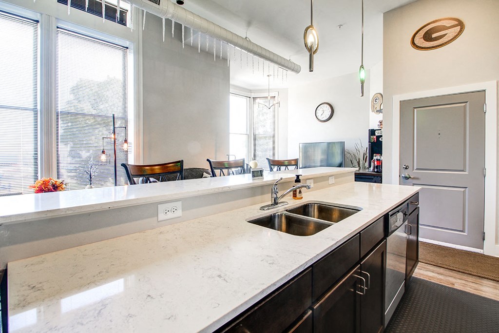 a large kitchen with a sink and a window