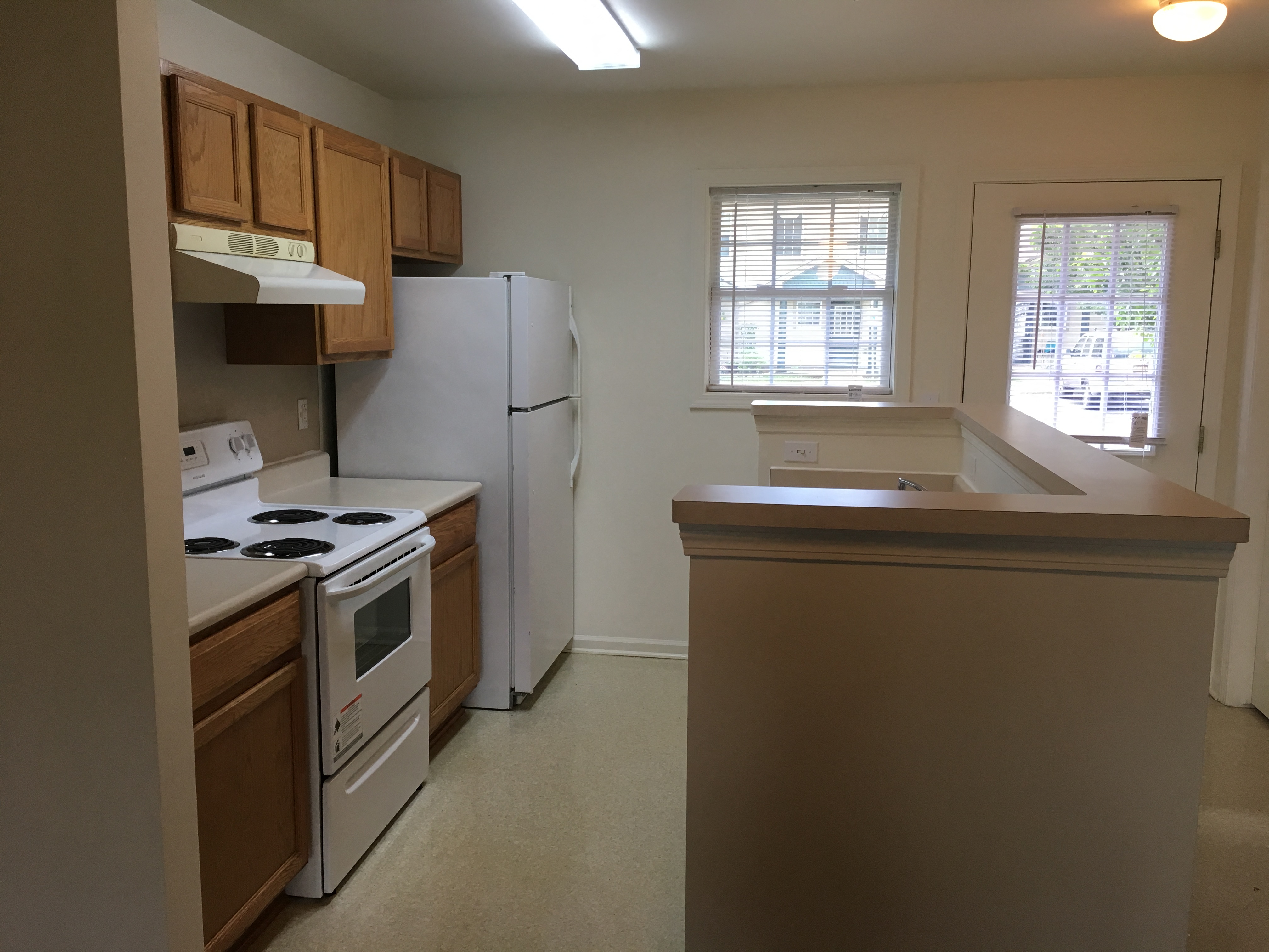 a kitchen with a stove refrigerator and a sink